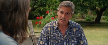 Movie still from “The Descendants” (2011), directed by Alexander Payne – A person wearing a hawaiian shirt; Close Up shot, Over the shoulder angle