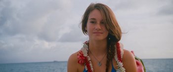 Movie still from “The Descendants” (2011), directed by Alexander Payne – A beautiful young lady wearing a necklace of flowers; Close Up shot, Over the shoulder angle