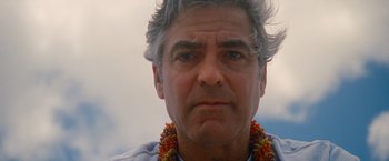 Movie still from “The Descendants” (2011), directed by Alexander Payne – A person wearing a necklace; Close Up shot, Low angle