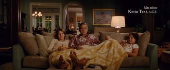 Movie still from “The Descendants” (2011), directed by Alexander Payne – A man and a woman sitting on a couch under a blanket; Wide shot, Over the shoulder angle