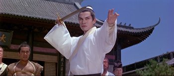 A man holding a sword in front of other men