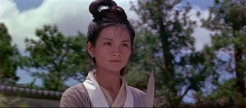 A young woman holding a knife in her hand