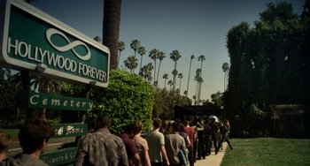 Movie still from “Comet” (2014), directed by Sam Esmail – A long line of people waiting to get into a store; Extreme Wide shot, High angle