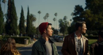 Movie still from “Comet” (2014), directed by Sam Esmail – Two young men standing on the side of the street; Medium shot, Over the shoulder angle