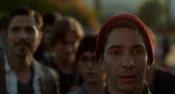 Movie still from “Comet” (2014), directed by Sam Esmail – A group of people standing in a line; Close Up shot, Over the shoulder angle