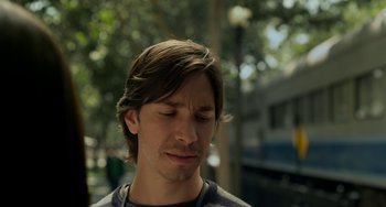 Movie still from “Comet” (2014), directed by Sam Esmail – A person with his eyes closed; Close Up shot, Over the shoulder angle
