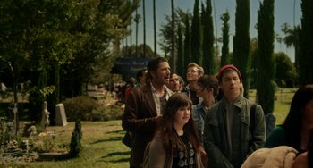 Movie still from “Comet” (2014), directed by Sam Esmail – A group of people standing next to each other on the grass; Medium shot, Over the shoulder angle