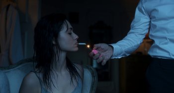Movie still from “Comet” (2014), directed by Sam Esmail – A person lighting a cigarette on a woman's face; Close Up shot, Over the shoulder angle