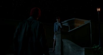 Movie still from “Comet” (2014), directed by Sam Esmail – A woman standing on steps at night next to a man; Extreme Wide shot, Over the shoulder angle