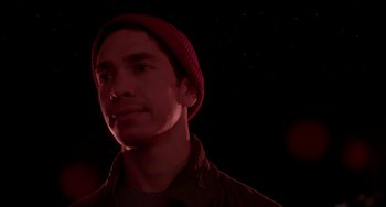Movie still from “Comet” (2014), directed by Sam Esmail – A man wearing a red hat and a brown jacket; Close Up shot, Low angle