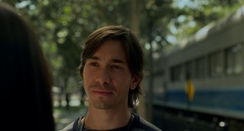 Movie still from “Comet” (2014), directed by Sam Esmail – A person with long brown hair; Close Up shot, Over the shoulder angle
