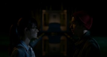 Movie still from “Comet” (2014), directed by Sam Esmail – A man and a woman standing next to each other in the dark; Close Up shot, Over the shoulder angle