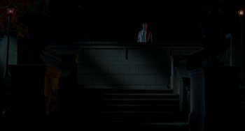 Movie still from “Comet” (2014), directed by Sam Esmail – A man standing on top of a staircase at night; Extreme Wide shot, Low angle