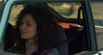 Movie still from “Comet” (2014), directed by Sam Esmail – A woman sitting in the driver's seat of a car; Close Up shot, Over the shoulder angle