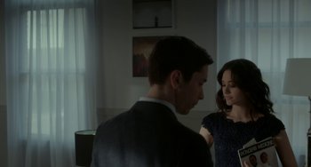 Movie still from “Comet” (2014), directed by Sam Esmail – A man and a woman standing next to each other in a room; Medium shot, Over the shoulder angle