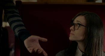 Movie still from “Comet” (2014), directed by Sam Esmail – A woman with glasses is looking at a man with his hand outstreched; Close Up shot, Over the shoulder angle