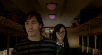 Movie still from “Comet” (2014), directed by Sam Esmail – A man and a woman standing next to each other; Medium shot, Low angle