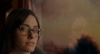 Movie still from “Comet” (2014), directed by Sam Esmail – A person wearing glasses; Close Up shot, Over the shoulder angle