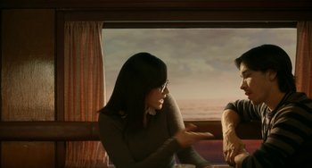Movie still from “Comet” (2014), directed by Sam Esmail – A woman and a man sitting in front of a window; Medium shot, Over the shoulder angle