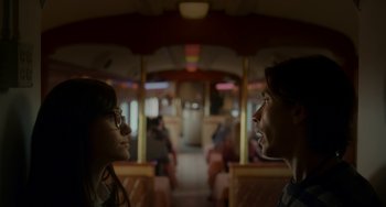 Movie still from “Comet” (2014), directed by Sam Esmail – Two people are talking on a train; Close Up shot, Low angle