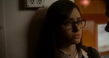 Movie still from “Comet” (2014), directed by Sam Esmail – A young woman wearing glasses and a white dress shirt; Close Up shot, Over the shoulder angle