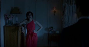 Movie still from “Comet” (2014), directed by Sam Esmail – A woman in a red dress standing in a dark room; Medium shot, Over the shoulder angle