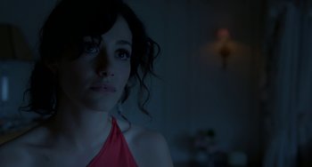 Movie still from “Comet” (2014), directed by Sam Esmail – A woman in a red dress is looking at the camera; Close Up shot, Over the shoulder angle