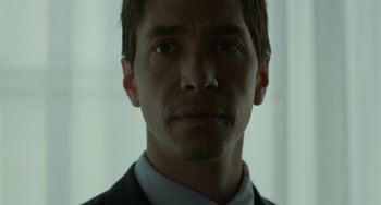 Movie still from “Comet” (2014), directed by Sam Esmail – A person wearing a suit and tie; Close Up shot, Low angle