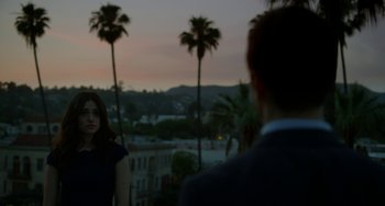 Movie still from “Comet” (2014), directed by Sam Esmail – A man and a woman standing next to each other on top of a building; Medium shot, Over the shoulder angle