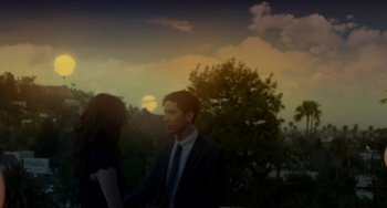 Movie still from “Comet” (2014), directed by Sam Esmail – A man and a woman holding hands in front of a tree; Medium shot, Over the shoulder angle