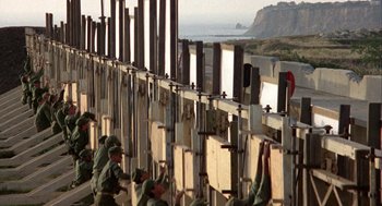 Movie still from “Coming Home” (1978), directed by Hal Ashby – A group of men standing on top of a wall; Extreme Wide shot, Low angle