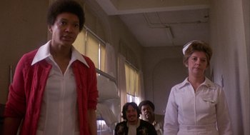 Movie still from “Coming Home” (1978), directed by Hal Ashby – A group of people standing next to each other in a room; Medium shot, Low angle