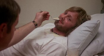 Movie still from “Coming Home” (1978), directed by Hal Ashby – A man in a hospital bed with a spoon in his mouth; Close Up shot, High angle