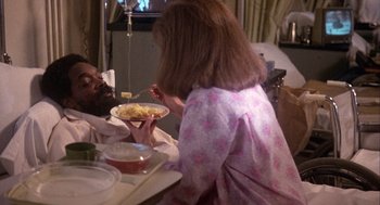 Movie still from “Coming Home” (1978), directed by Hal Ashby – A woman sitting at a table eating macaroni and cheese; Medium shot, High angle