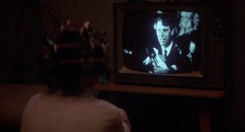 Movie still from “Coming Home” (1978), directed by Hal Ashby – A person sitting in front of a television; Close Up shot, Over the shoulder angle
