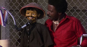 Movie still from “Coming Home” (1978), directed by Hal Ashby – A man standing next to another man holding a microphone; Close Up shot, High angle