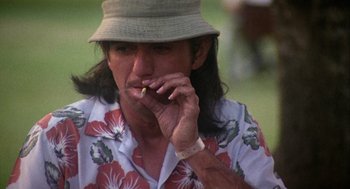 Movie still from “Coming Home” (1978), directed by Hal Ashby – A man in a hat is smoking a cigarette; Close Up shot, Low angle