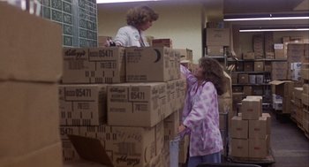 Movie still from “Coming Home” (1978), directed by Hal Ashby – A woman and a girl are standing next to boxes in a warehouse; Medium shot, Over the shoulder angle