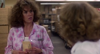 Movie still from “Coming Home” (1978), directed by Hal Ashby – A woman holding a book in a warehouse; Close Up shot, Over the shoulder angle