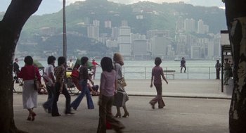 Movie still from “Coming Home” (1978), directed by Hal Ashby – A group of people walking down a sidewalk near a body of water; Extreme Wide shot, High angle