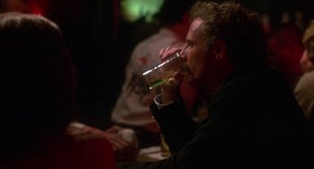 Movie still from “Coming Home” (1978), directed by Hal Ashby – A man sitting at a table drinking a beer; Close Up shot, Over the shoulder angle