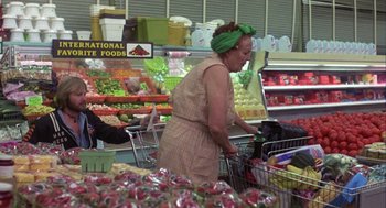 Movie still from “Coming Home” (1978), directed by Hal Ashby – An older woman is shopping in a grocery store; Medium shot, Over the shoulder angle