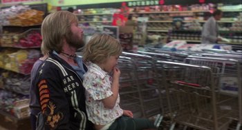 Movie still from “Coming Home” (1978), directed by Hal Ashby – A man and a little girl sitting next to each other in a store; Medium shot, Over the shoulder angle