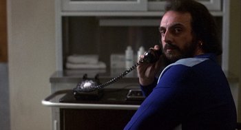 Movie still from “Coming Home” (1978), directed by Hal Ashby – A man sitting at a table talking on a phone; Close Up shot, Low angle