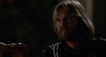 Movie still from “Coming Home” (1978), directed by Hal Ashby – A person with long hair and a beard; Close Up shot, Over the shoulder angle