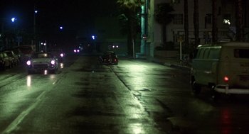 Movie still from “Coming Home” (1978), directed by Hal Ashby – A car driving down a street at night; Extreme Wide shot, High angle