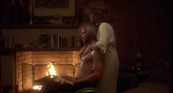 Movie still from “Coming Home” (1978), directed by Hal Ashby – A man and a woman in front of a fireplace; Medium shot, High angle