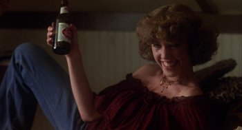 Movie still from “Coming Home” (1978), directed by Hal Ashby – A woman holding up a bottle of beer in her hand; Medium shot, Low angle