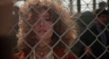 Movie still from “Coming Home” (1978), directed by Hal Ashby – A person behind a chain link fence; Close Up shot, Low angle