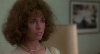 Movie still from “Coming Home” (1978), directed by Hal Ashby – A person wearing a necklace; Close Up shot, Over the shoulder angle